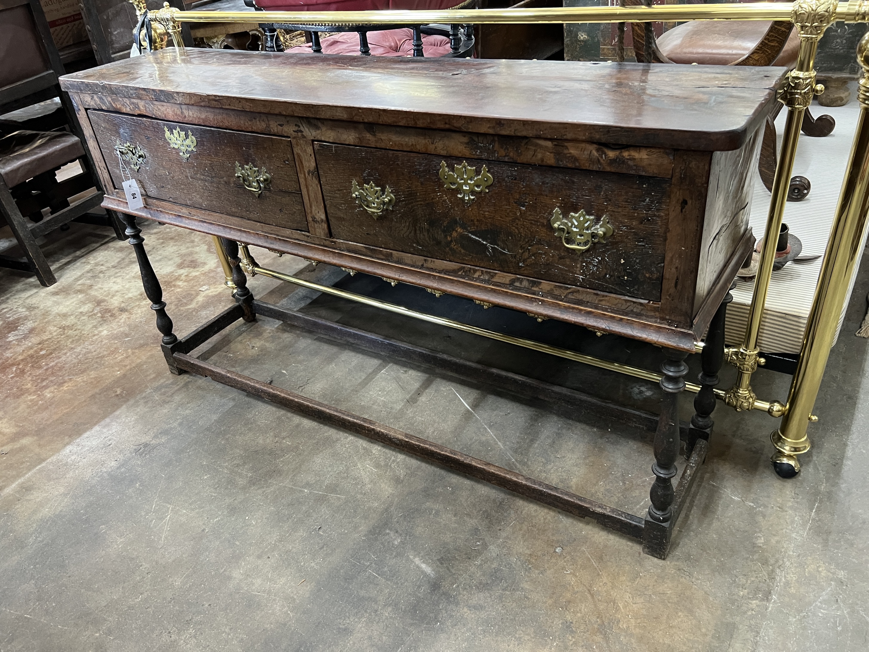 A 17th century and later oak and fruitwood low dresser, fitted two drawers, width 153cm, depth 35cm, height 86cm